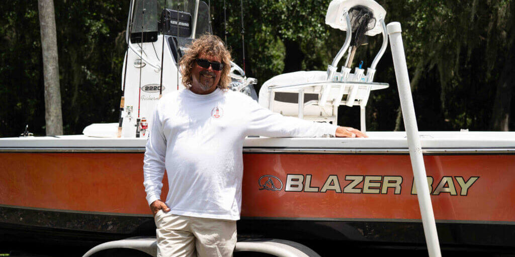 Captain Kurstan standing by boat_Crescent Lake_Brandy Jo Hastings_ Captain Kurstan standing by boat_Crescent Lake_Brandy Jo Hastings_